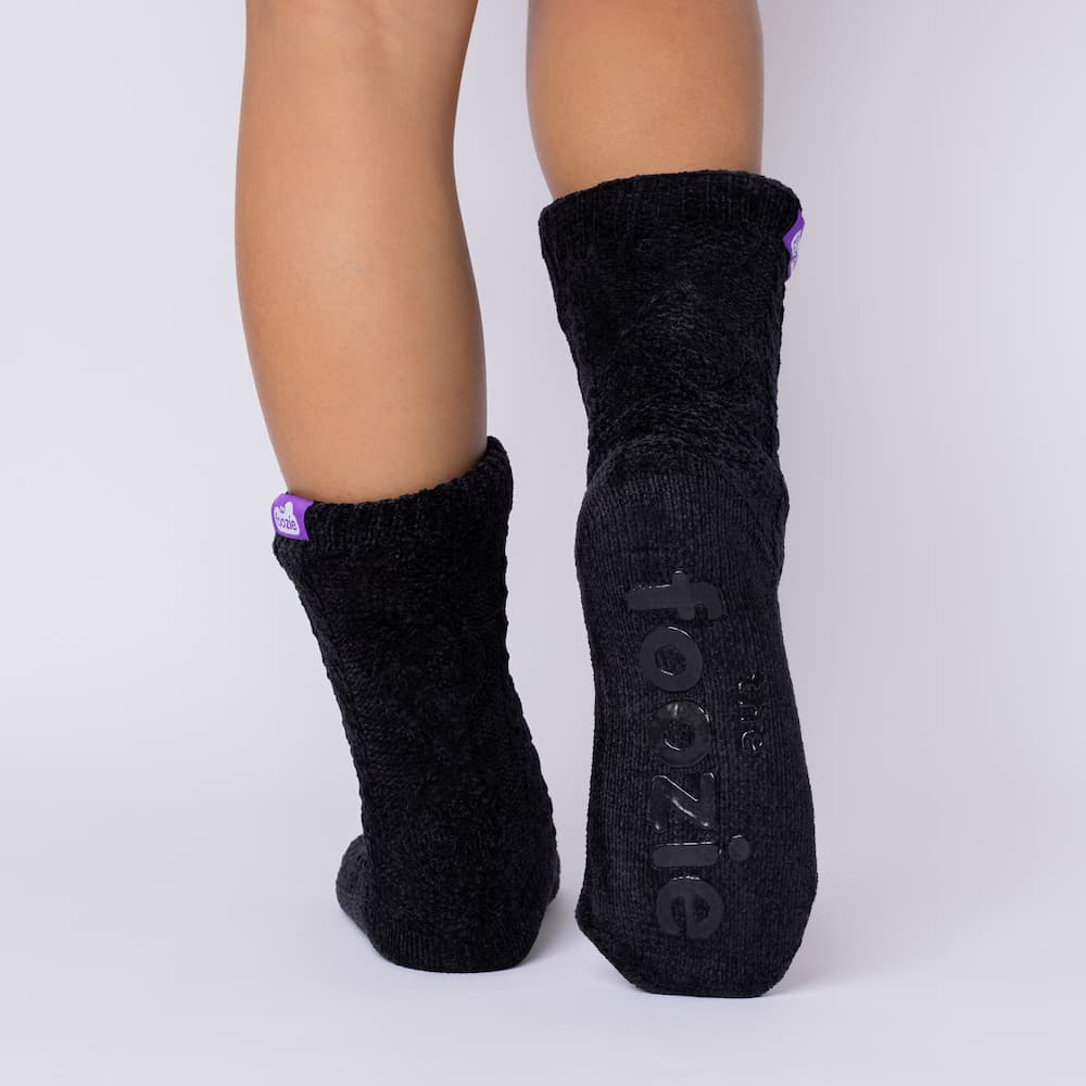 The Foozie™ Move in Black, back view showing the diamond cable knit and the foozie grips on the sole