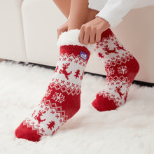 Load image into Gallery viewer, The Foozie™ Christmas Reindeer slipper socks, red and white reindeer knit, hands pulling up the sherpa cuff on a fluffy rug
