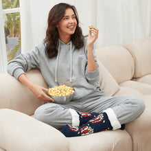 Load image into Gallery viewer, The Foozie™ Popcorn slipper socks, worn by a woman in a hoodie on the sofa with a bowl of popcorn
