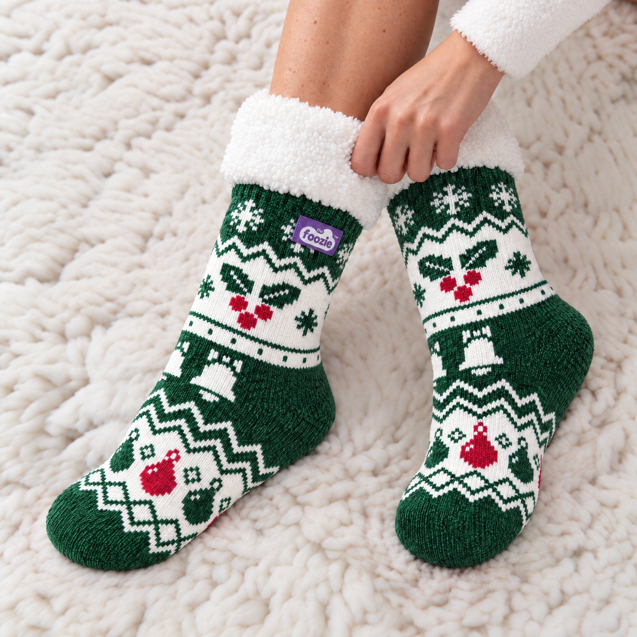 The Foozie™ Christmas Holly slipper socks, close-up on a rug