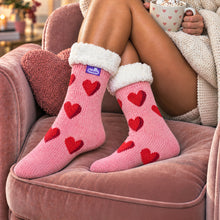 Load image into Gallery viewer, The Foozie™ Love Heart slipper socks, worn on the sofa
