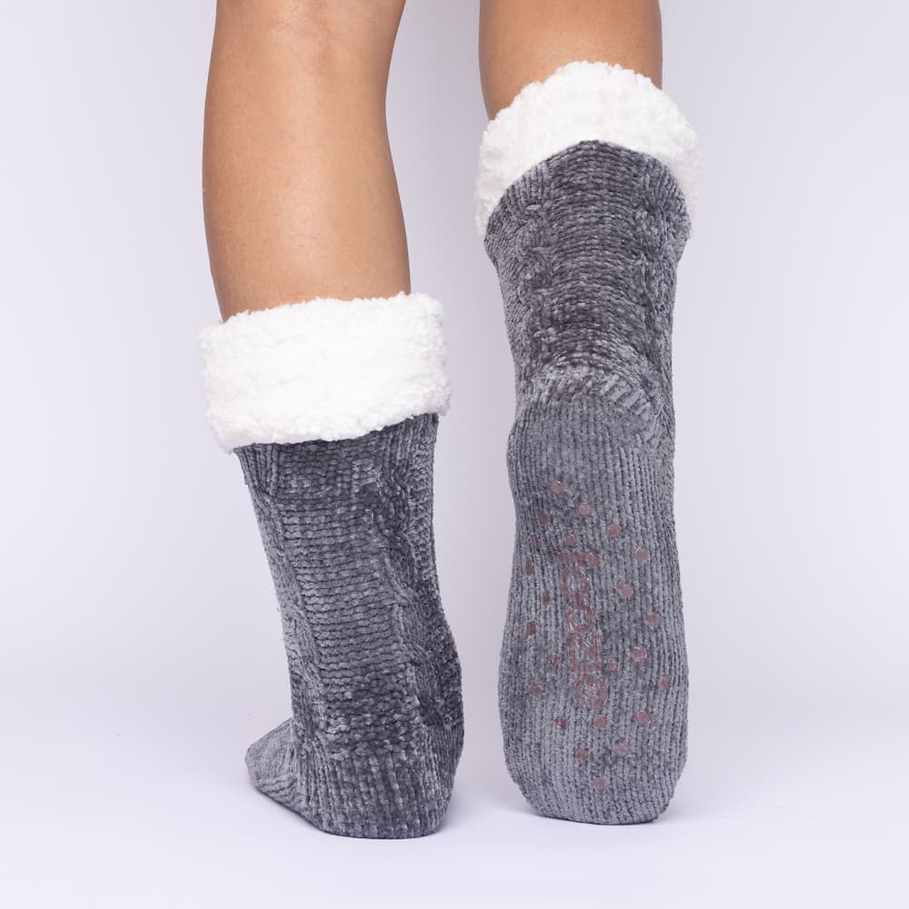 The Foozie™ in Dark Gray, back view with one foot raised to show the non-slip grips on the sole