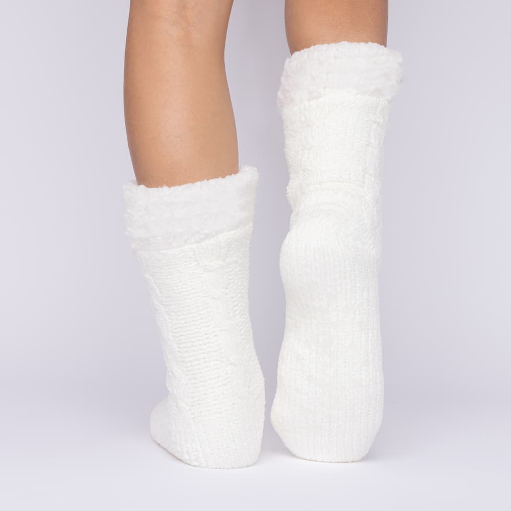 The Foozie™ in White, back view with one foot raised to show the sole
