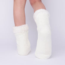Load image into Gallery viewer, The Foozie™ in White, back view worn in Kids/Small with one foot raised to show the sole
