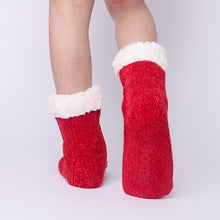 Load image into Gallery viewer, The Foozie™ in Red, back view worn in Kids/Small with one foot raised to show the non-slip grips on the sole

